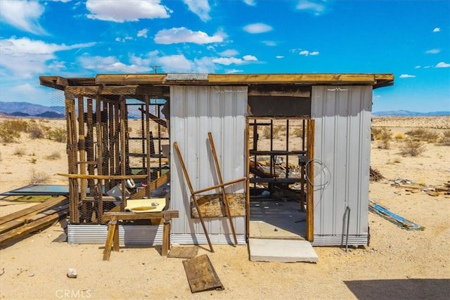 view of outdoor structure with an outdoor structure, a mountain view, and a desert view