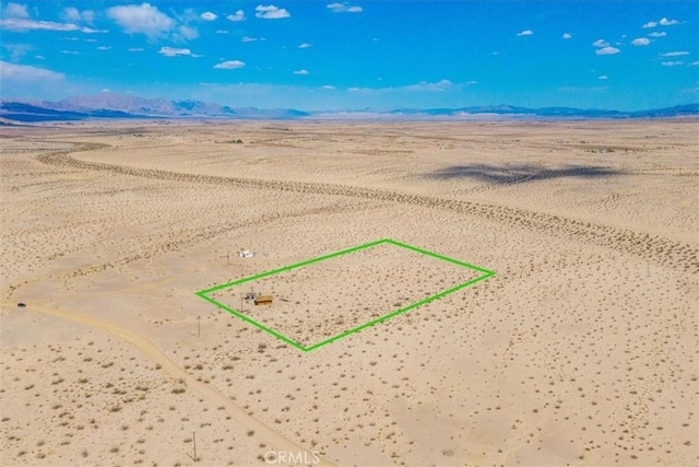 birds eye view of property with a mountain view, a rural view, and view of desert