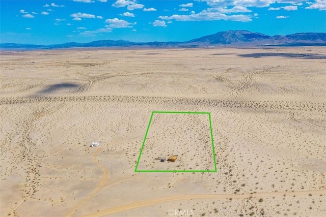 birds eye view of property with a mountain view and a desert view