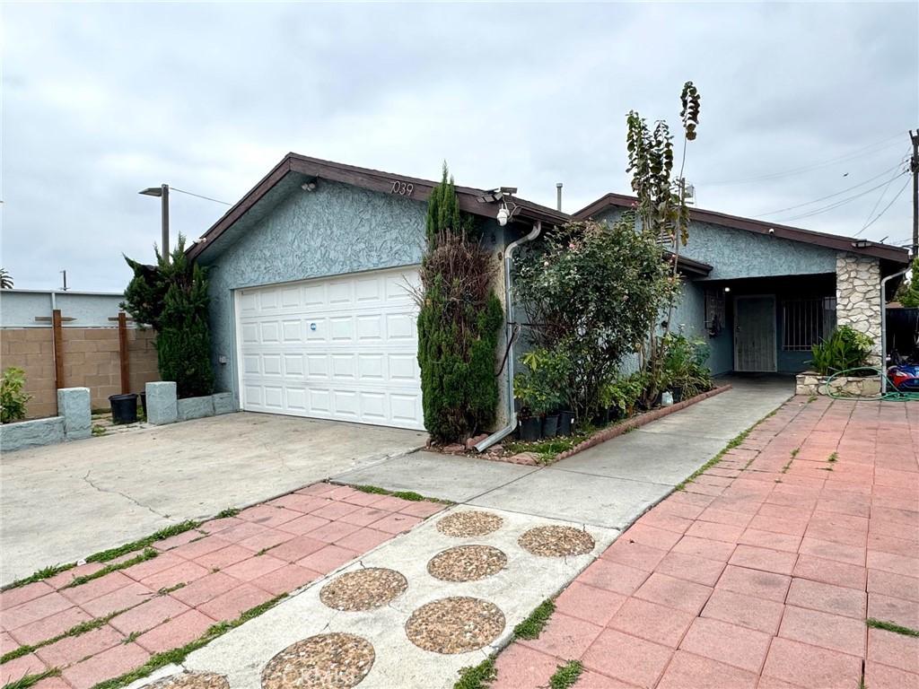 single story home featuring concrete driveway, a garage, and stucco siding