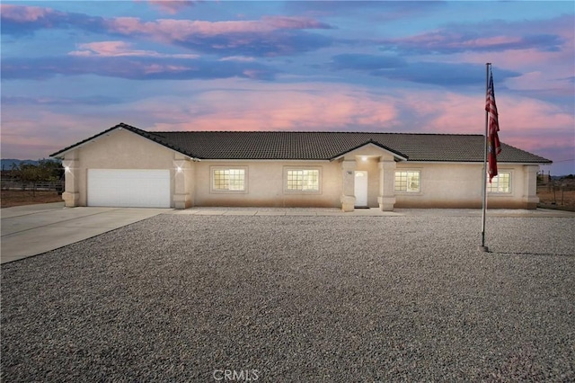 21683 Ramona Rd, Apple Valley, CA 92307 - ranch-style home with concrete driveway, stucco siding, a tile roof, and a garage