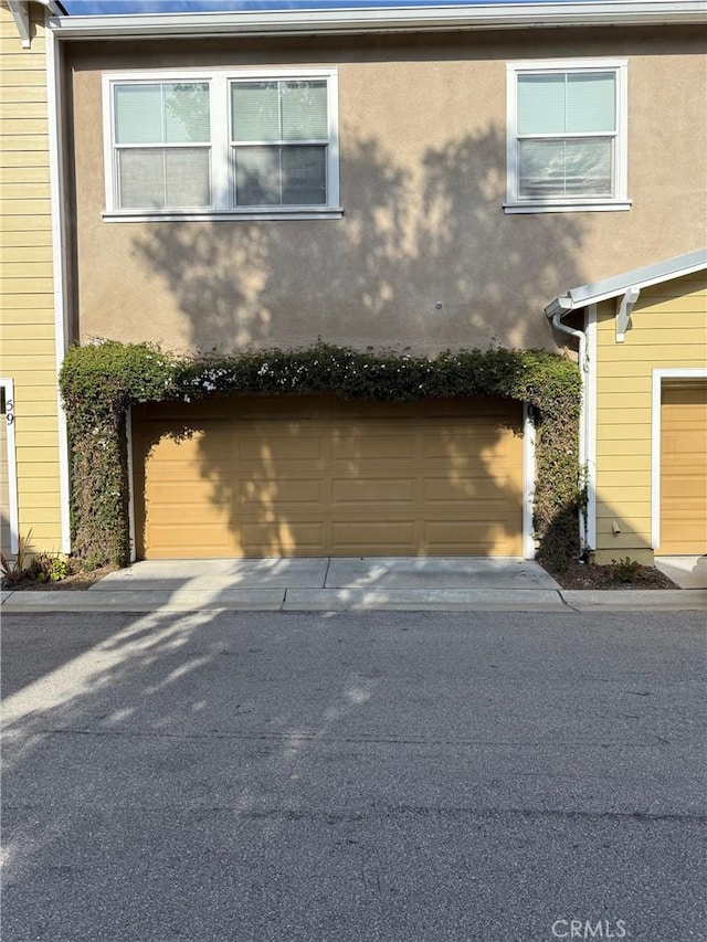 3591 Sacramento Dr Unit 86, San Luis Obispo, CA 93401 - view of home's exterior with stucco siding and a garage