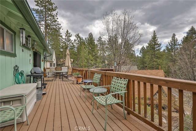 39177 Arapahoe Rd, Fawnskin, CA 92333 - wooden terrace with grilling area and outdoor dining area