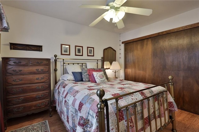 bedroom with a ceiling fan, a closet, and wood finished floors