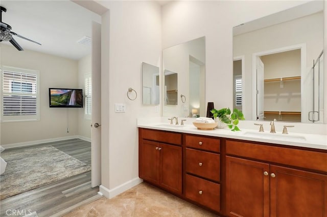 149 Luneta Ln, Rancho Mission Viejo, CA 92694 - bathroom with ceiling fan, double vanity, baseboards, and wood finished floors
