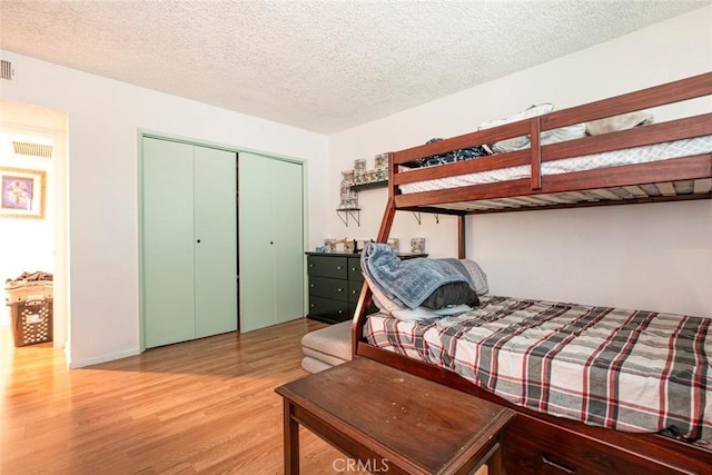 17151 Roscoe Blvd Unit 21, Northridge, CA 91325 - bedroom featuring wood finished floors, a closet, and a textured ceiling