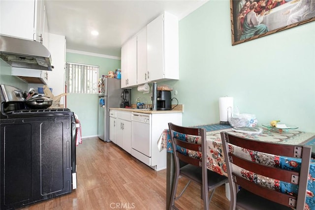 17151 Roscoe Blvd Unit 21, Northridge, CA 91325 - kitchen featuring white dishwasher, under cabinet range hood, crown molding, freestanding refrigerator, and light countertops