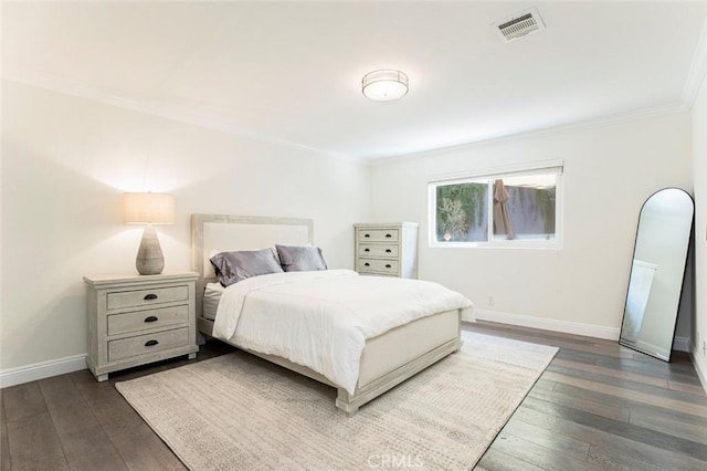 bedroom with baseboards, visible vents, crown molding, and dark wood-type flooring