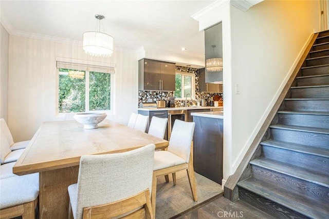 dining room with stairs and crown molding