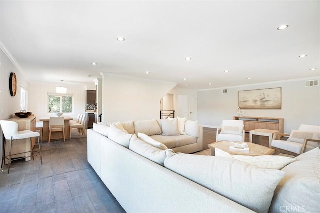 living room featuring recessed lighting, visible vents, ornamental molding, and hardwood / wood-style flooring
