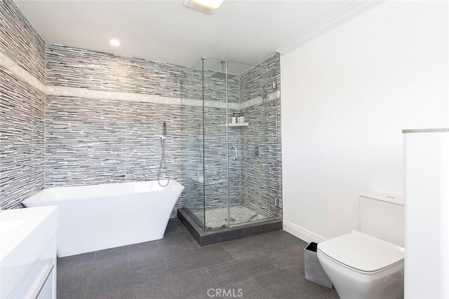 bathroom with a stall shower, tile walls, a freestanding tub, and toilet