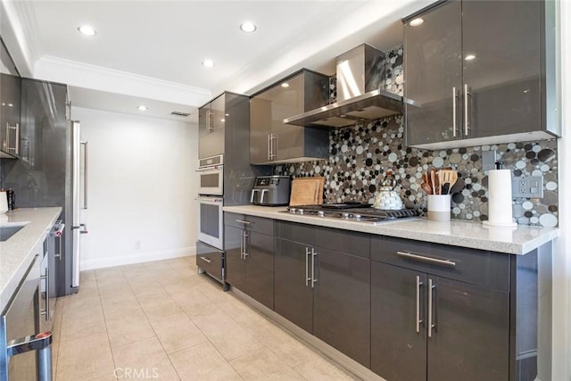 kitchen with wall chimney range hood, ornamental molding, stainless steel gas cooktop, backsplash, and light stone countertops