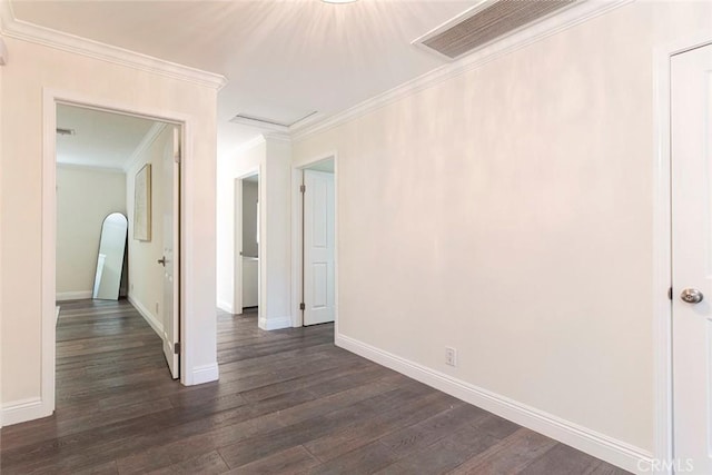 empty room featuring visible vents, baseboards, and dark wood-type flooring