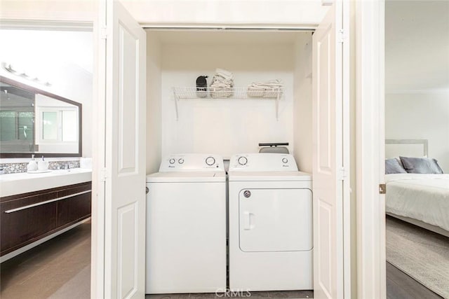 washroom featuring laundry area, ornamental molding, and separate washer and dryer