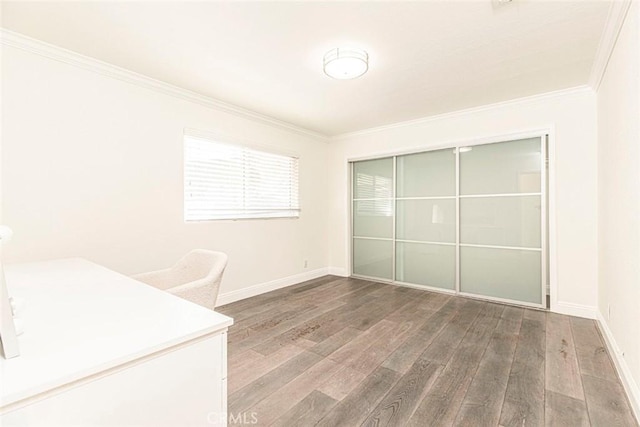 unfurnished office with wood finished floors, baseboards, and ornamental molding