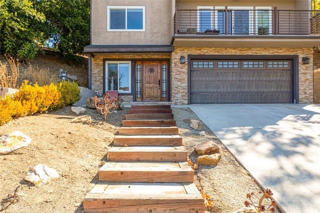 traditional-style house with a balcony, a garage, stucco siding, concrete driveway, and stone siding