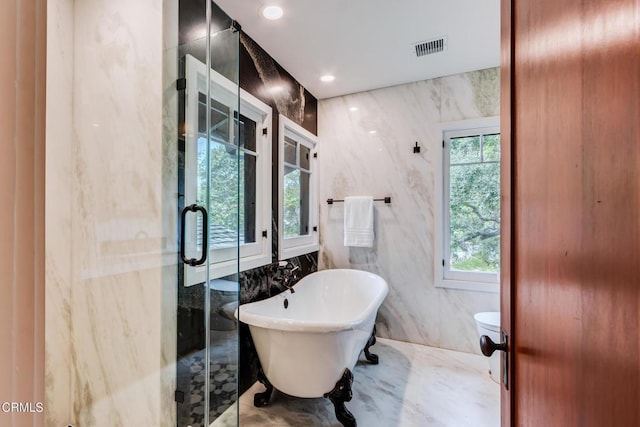 full bathroom featuring tile walls, visible vents, a shower stall, a freestanding tub, and recessed lighting