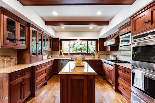 kitchen featuring stainless steel appliances, tasteful backsplash, a warming drawer, and beam ceiling