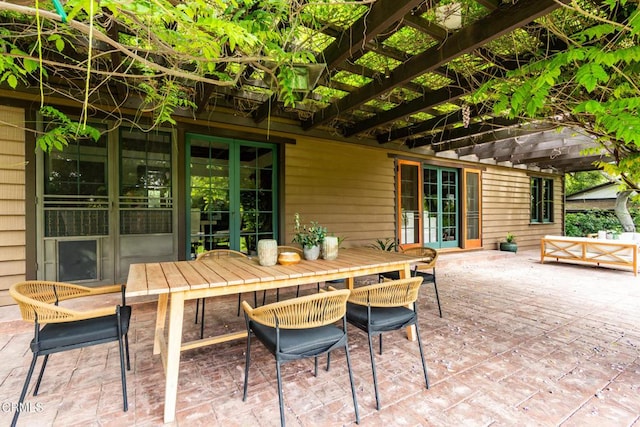 view of patio featuring french doors, outdoor dining area, and a pergola