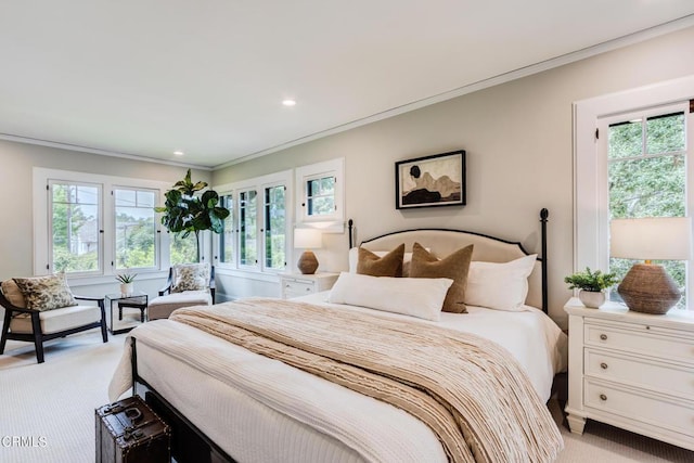 bedroom with ornamental molding, recessed lighting, and light colored carpet