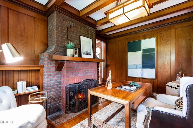 office area featuring a fireplace, wood walls, beam ceiling, and wood finished floors