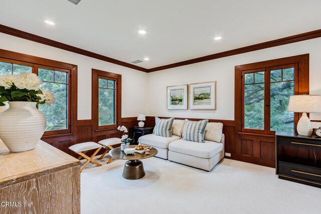 living room featuring light colored carpet, plenty of natural light, wainscoting, and recessed lighting