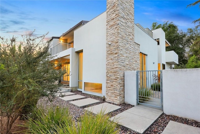 1145 E Grandview Ave, Sierra Madre, CA 91024 - view of home's exterior featuring a gate, a balcony, and stucco siding