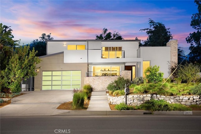 1145 E Grandview Ave, Sierra Madre, CA 91024 - contemporary house with concrete driveway, stucco siding, and a chimney