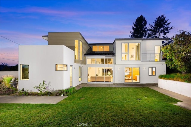 1145 E Grandview Ave, Sierra Madre, CA 91024 - rear view of property featuring a balcony, stucco siding, a lawn, and a patio