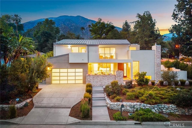 1145 E Grandview Ave, Sierra Madre, CA 91024 - modern home featuring driveway, stucco siding, a mountain view, and a balcony
