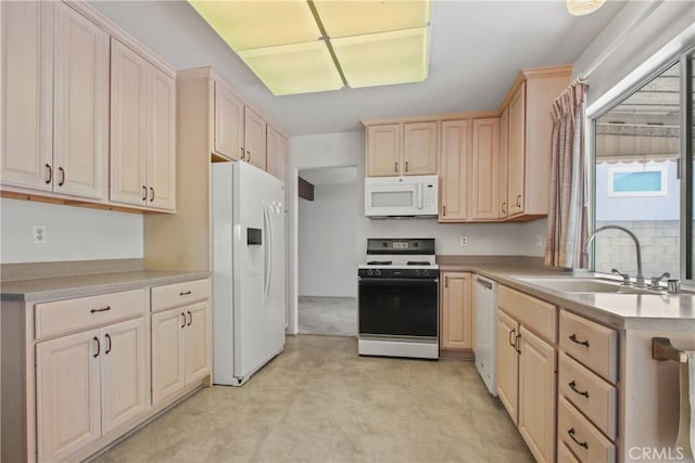 kitchen with white appliances, light brown cabinets, light countertops, and a sink