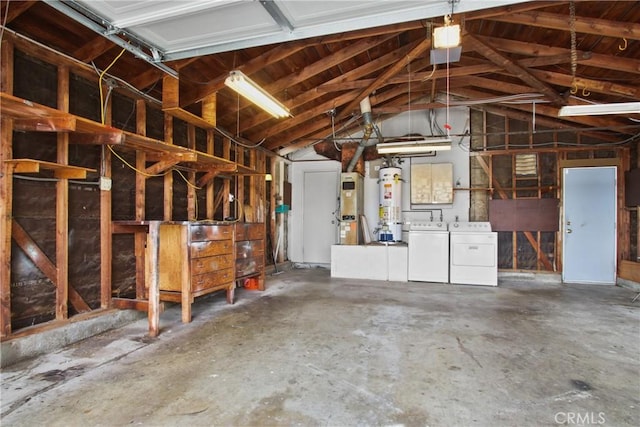 garage with secured water heater, washer and dryer, and water heater