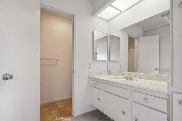 bathroom featuring baseboards and vanity