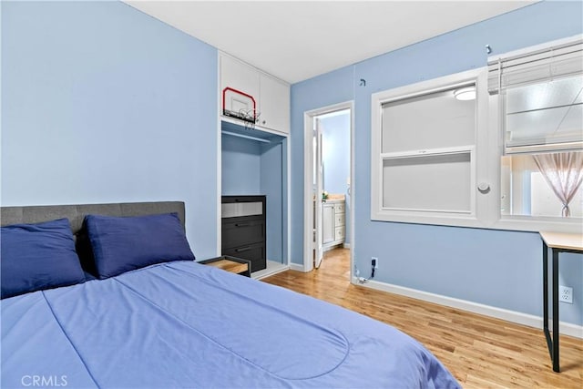 3348 Burritt Way, La Crescenta, CA 91214 - bedroom with ensuite bathroom, wood finished floors, and baseboards