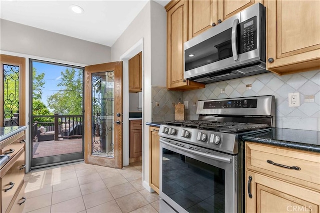 3348 Burritt Way, La Crescenta, CA 91214 - kitchen featuring light tile patterned floors, stainless steel appliances, tasteful backsplash, and dark stone countertops