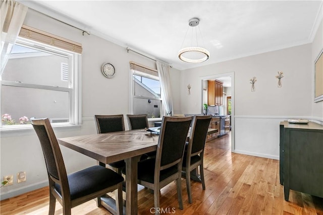 3348 Burritt Way, La Crescenta, CA 91214 - dining area with light wood finished floors, ornamental molding, a notable chandelier, and baseboards