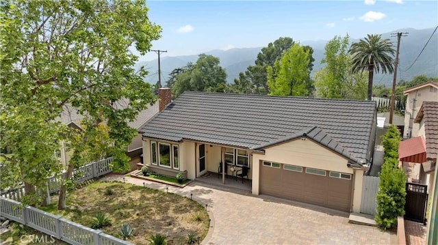 3348 Burritt Way, La Crescenta, CA 91214 - view of front facade with fence, a garage, a tiled roof, a chimney, and decorative driveway