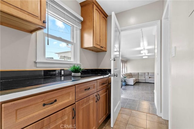 3348 Burritt Way, La Crescenta, CA 91214 - kitchen with light tile patterned floors, brown cabinets, and a healthy amount of sunlight
