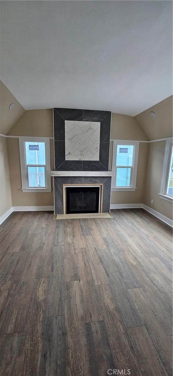 208 S Burris Ave, Compton, CA 90221 - unfurnished living room with vaulted ceiling, wood finished floors, baseboards, and a fireplace