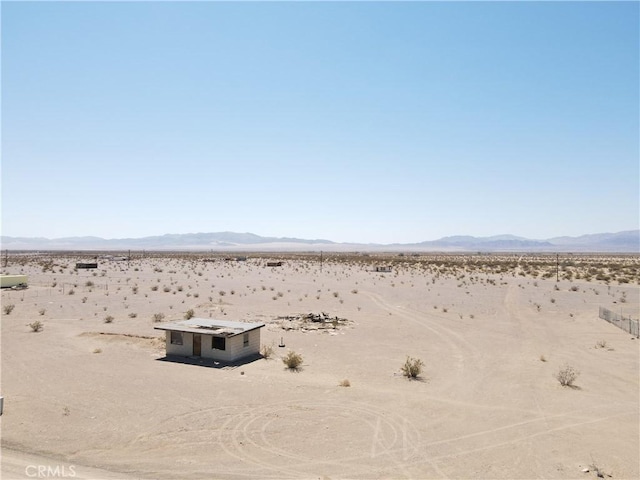 view of yard with a rural view, a mountain view, and a desert view
