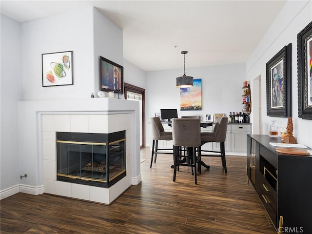 5447 Marine Ave Unit 7, Lawndale, CA 90260 - dining area featuring baseboards, dark wood-style flooring, and a fireplace