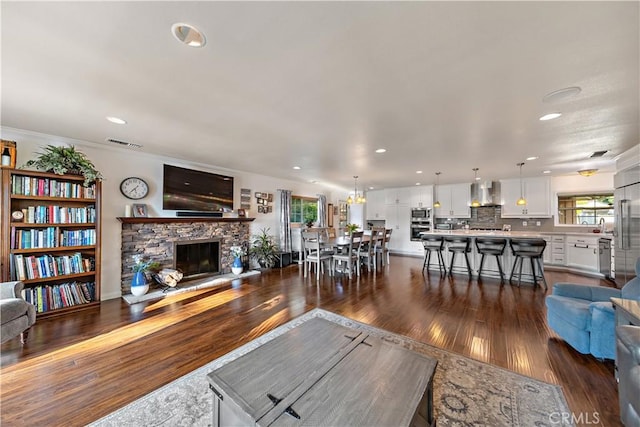 living room featuring dark wood finished floors, visible vents, and recessed lighting