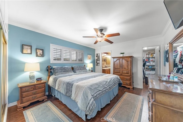 bedroom featuring ornamental molding, a closet, dark wood-style flooring, and a spacious closet