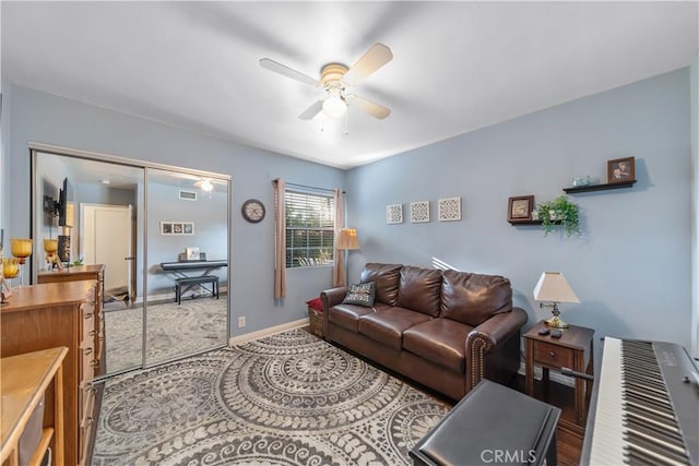 carpeted living area featuring visible vents, baseboards, and ceiling fan