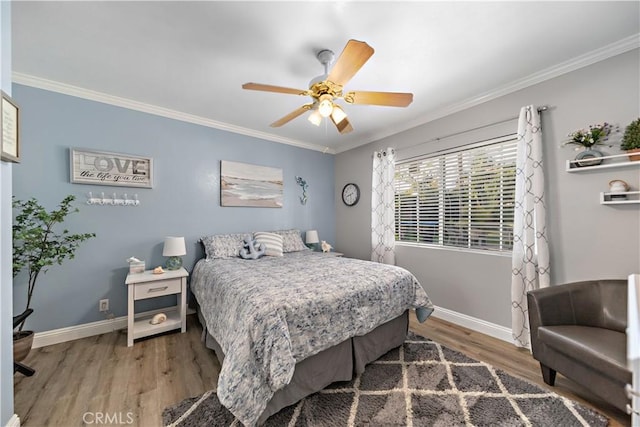 bedroom featuring crown molding, baseboards, ceiling fan, and wood finished floors