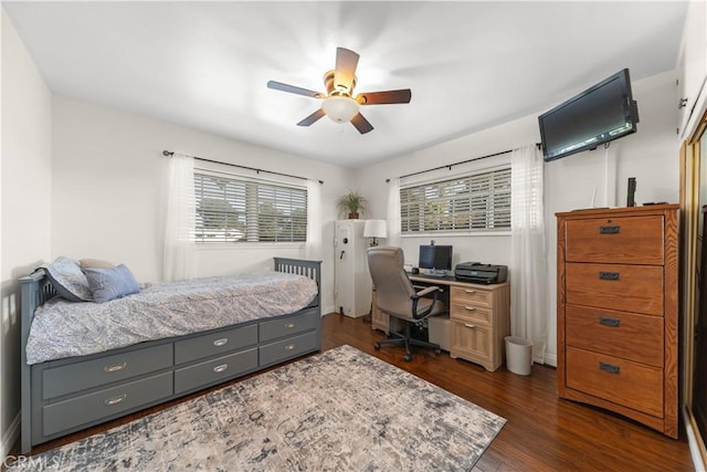bedroom with dark wood finished floors and a ceiling fan