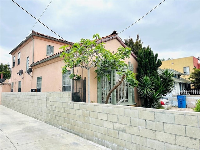 606 W 57th St, Los Angeles, CA 90037 - view of home's exterior featuring stucco siding