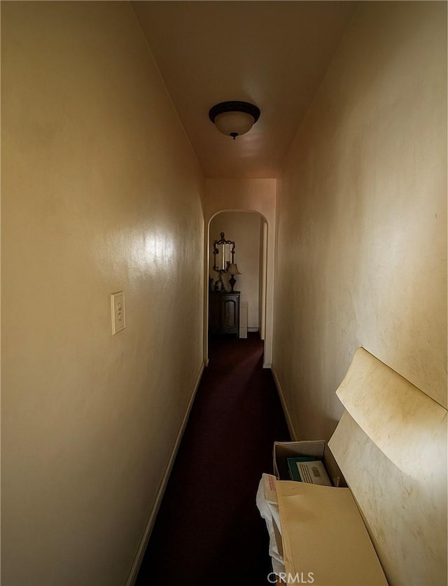 606 W 57th St, Los Angeles, CA 90037 - hallway featuring arched walkways and dark colored carpet