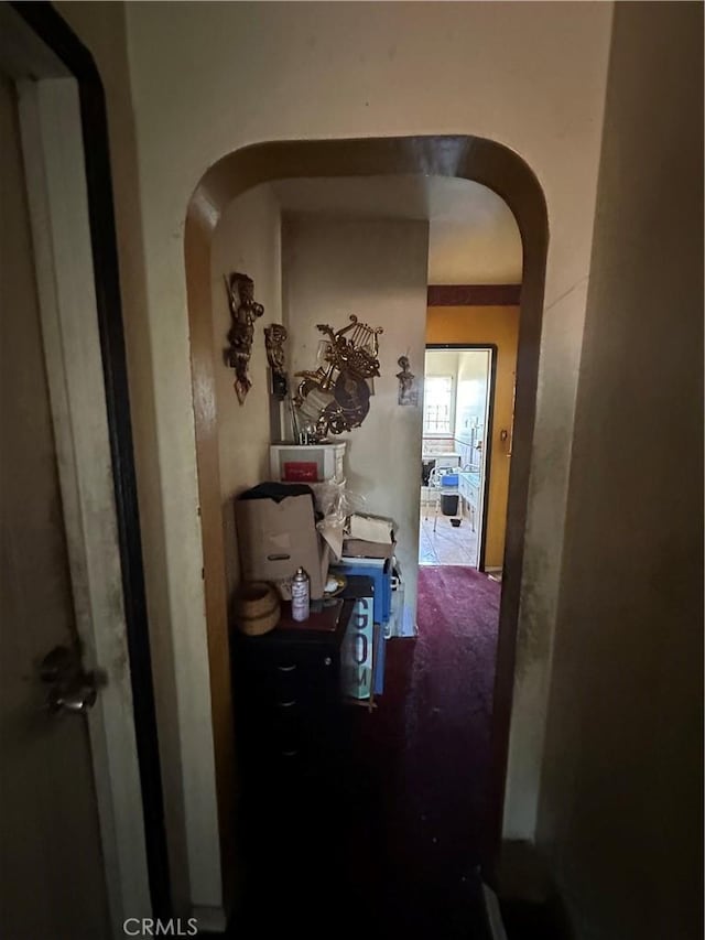 606 W 57th St, Los Angeles, CA 90037 - hallway with arched walkways and carpet floors