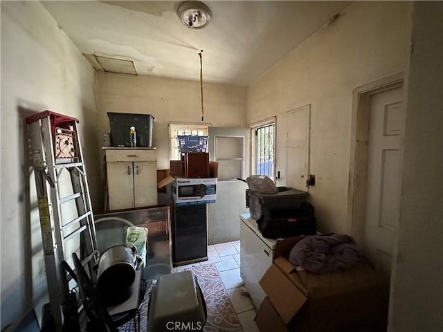 606 W 57th St, Los Angeles, CA 90037 - kitchen featuring stainless steel microwave and light tile patterned floors